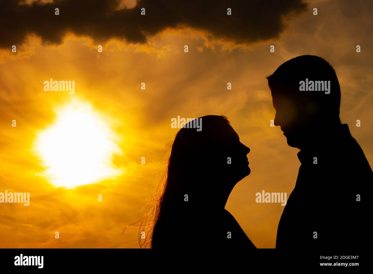 Silhouette of a couple in love during sunset Stock Photo - Alamy