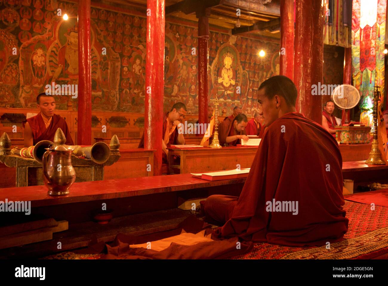 Prayer hall with monks in session, Likir monastery, Ladakh, Jammu and Kashmir, India Stock Photo