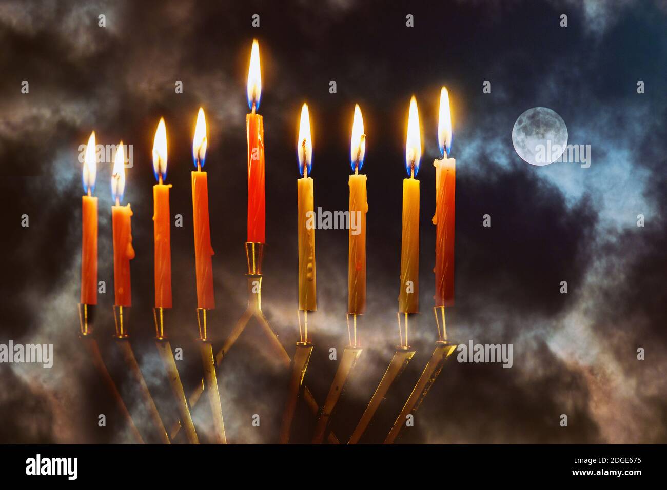 Menorah with candles for hannukah holiday celebration with full moon night sky background Stock Photo