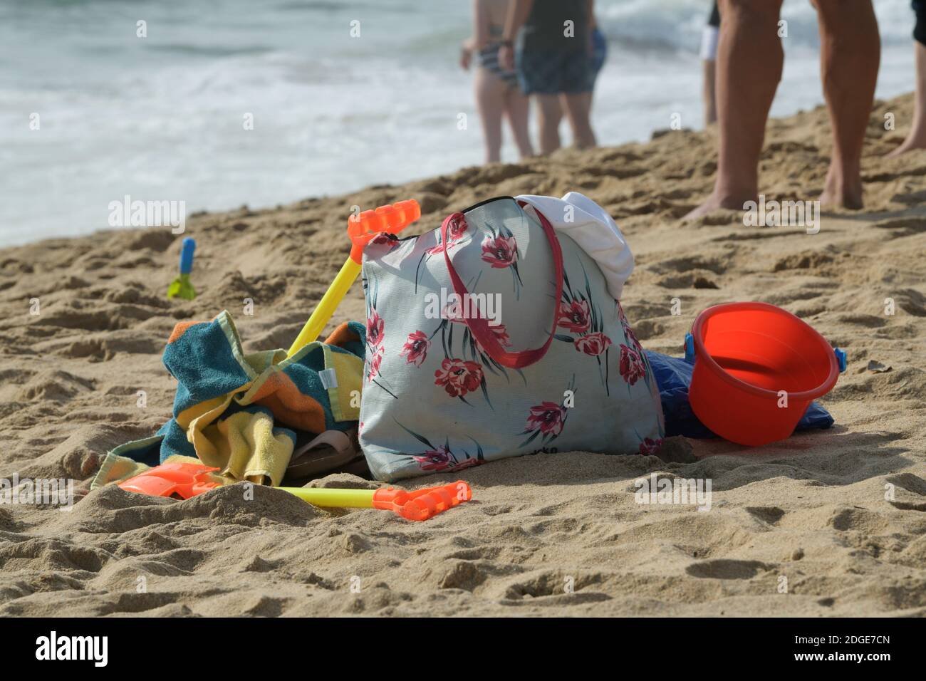 Objects, carrier bag and toys on beach sand, holiday concept, collection of things for seaside vacation, still life items, luggage Stock Photo