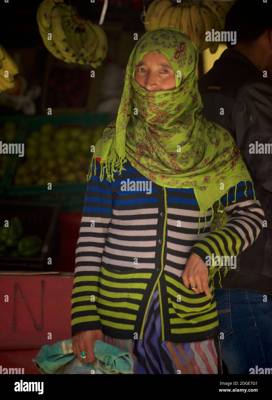 Woman in headcloth from the predominantly muslim Kargil area of Ladakh, shopping in a village store on the outskirts of Kargil,  Jammu and Kashmir, India Stock Photo
