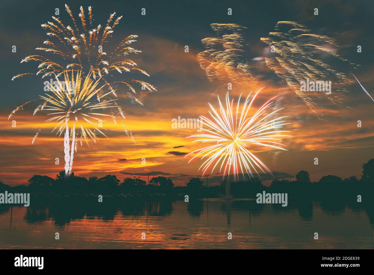 Fireworks display on majestic beautiful sunset sky lake s Stock Photo