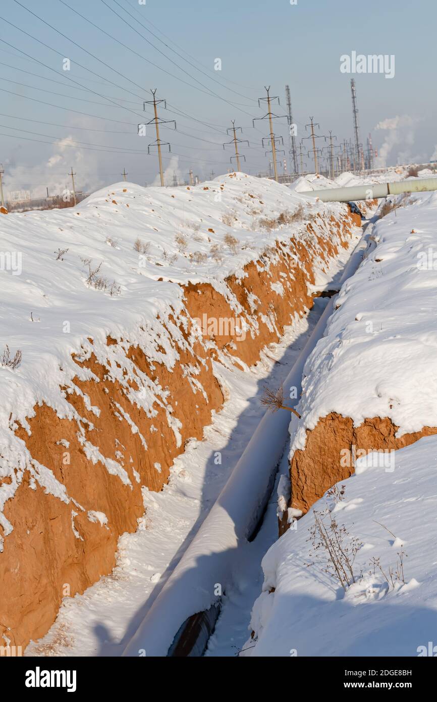 Pipeline laying in polymeric insulation in a trench dug Stock Photo