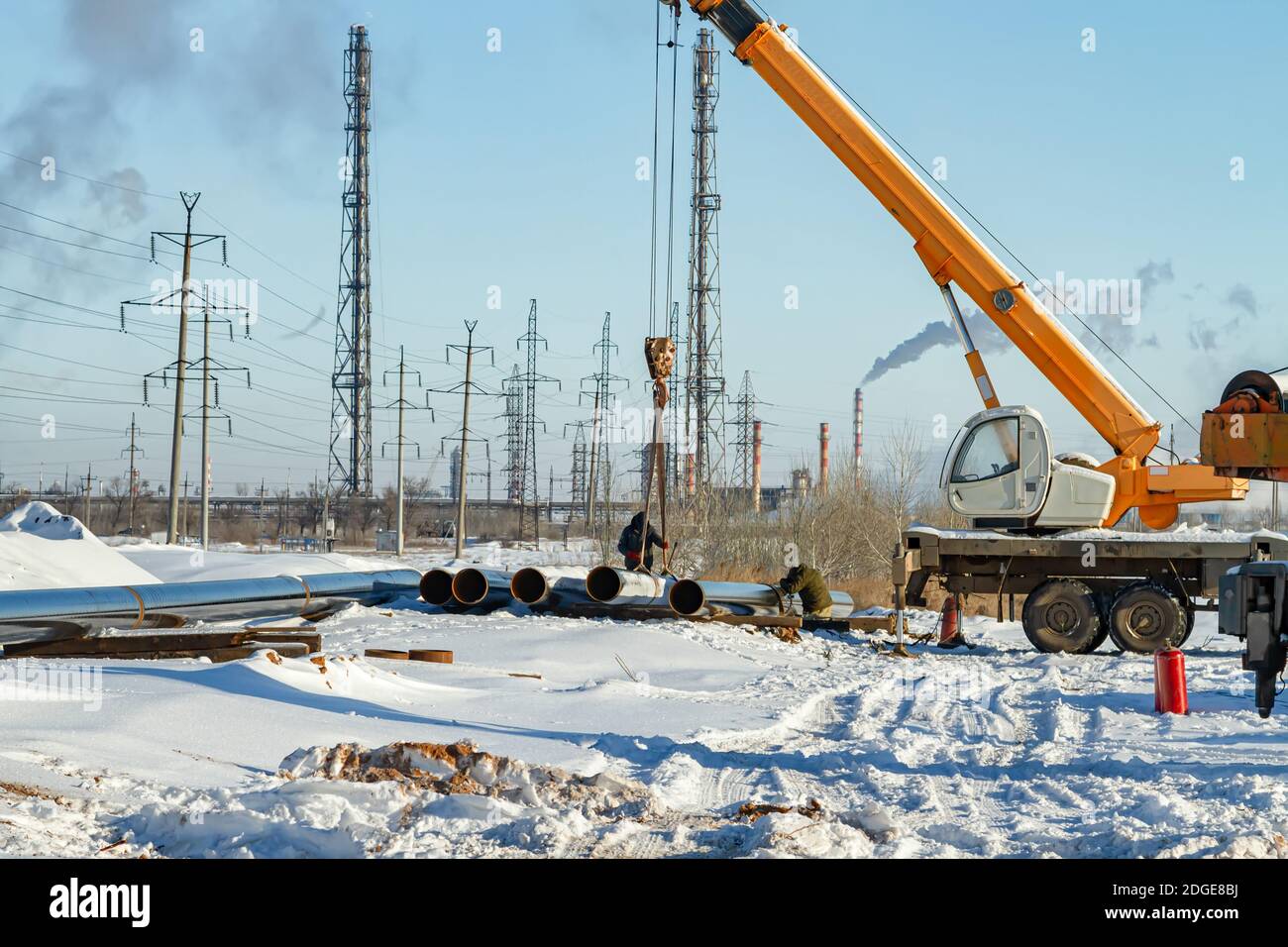 Construction work on pipe laying of pipeline into the trench using a crane Stock Photo