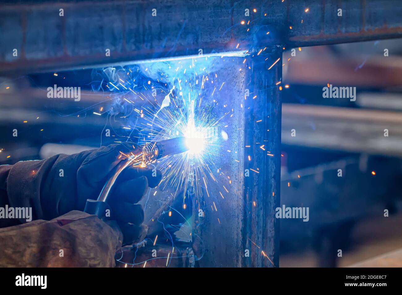 Semi-automatic welding with sparks and smoke Stock Photo