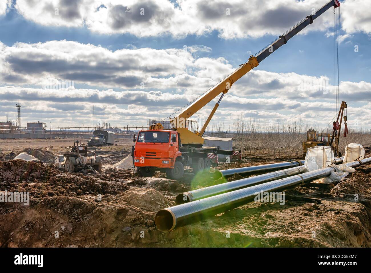 Construction work on pipe laying of pipeline into the trench using a