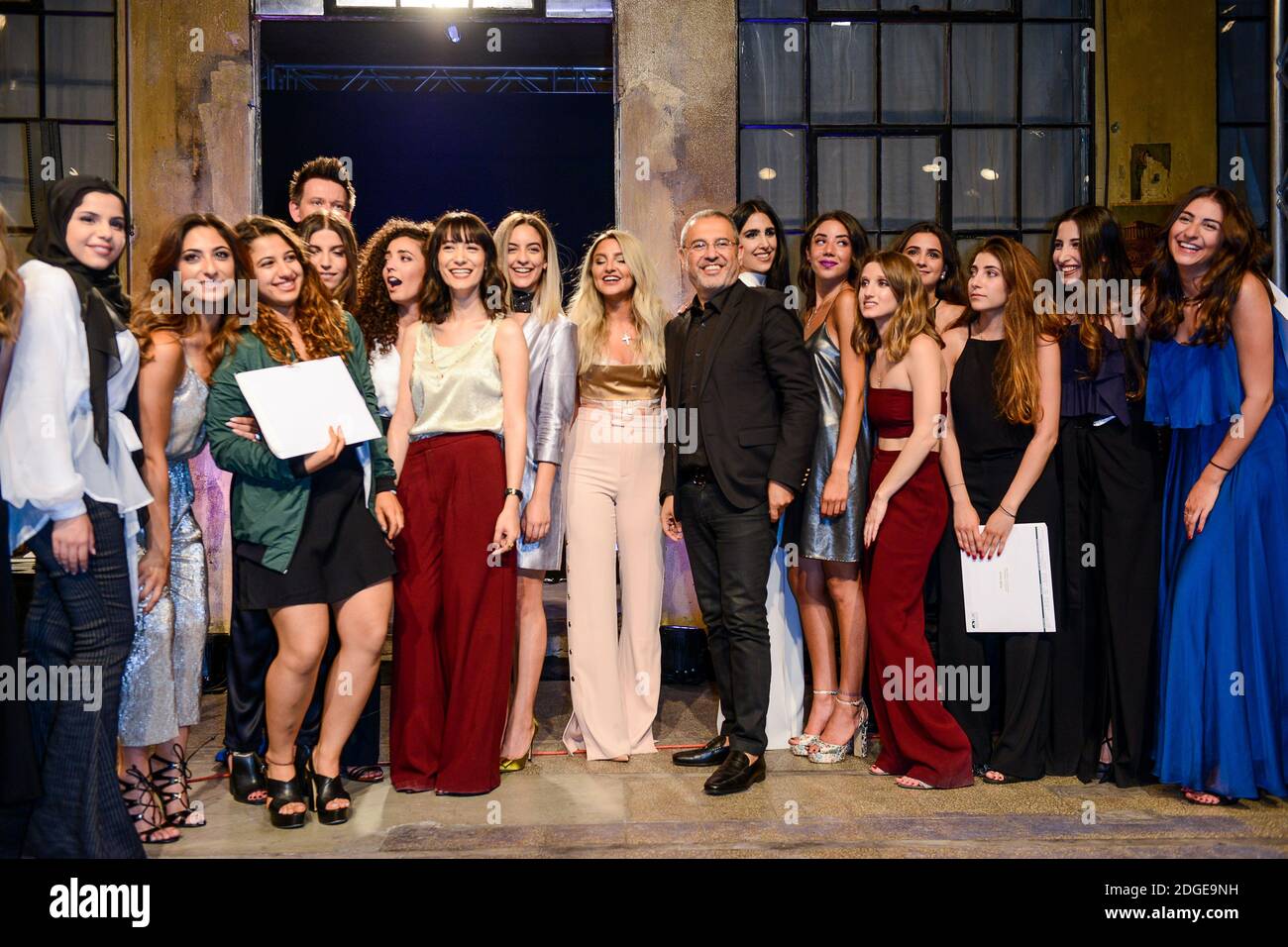 Fashion designer Elie Saab poses with the first 16 graduates of LAU ...