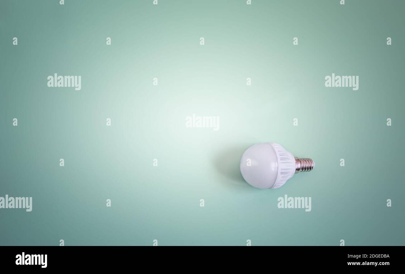 Electric energy-saving lamp on a light background. Stock Photo