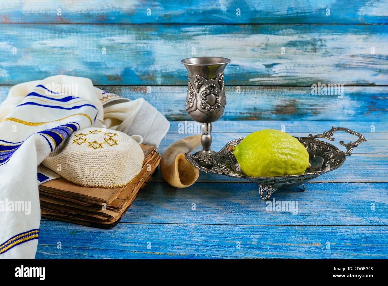 Jewish ritual festival of Sukkot in the jewish religious symbol Etrog, lulav, hadas, arava tallit praying book kippah and shofar Stock Photo