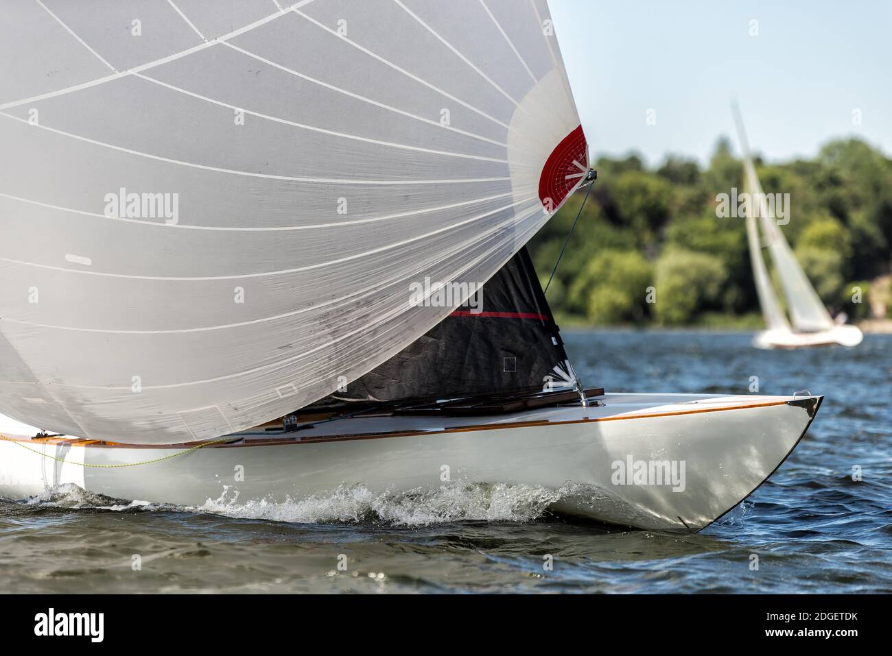 Classic sailing yacht with spinnaker on a lake in a regatta Stock Photo