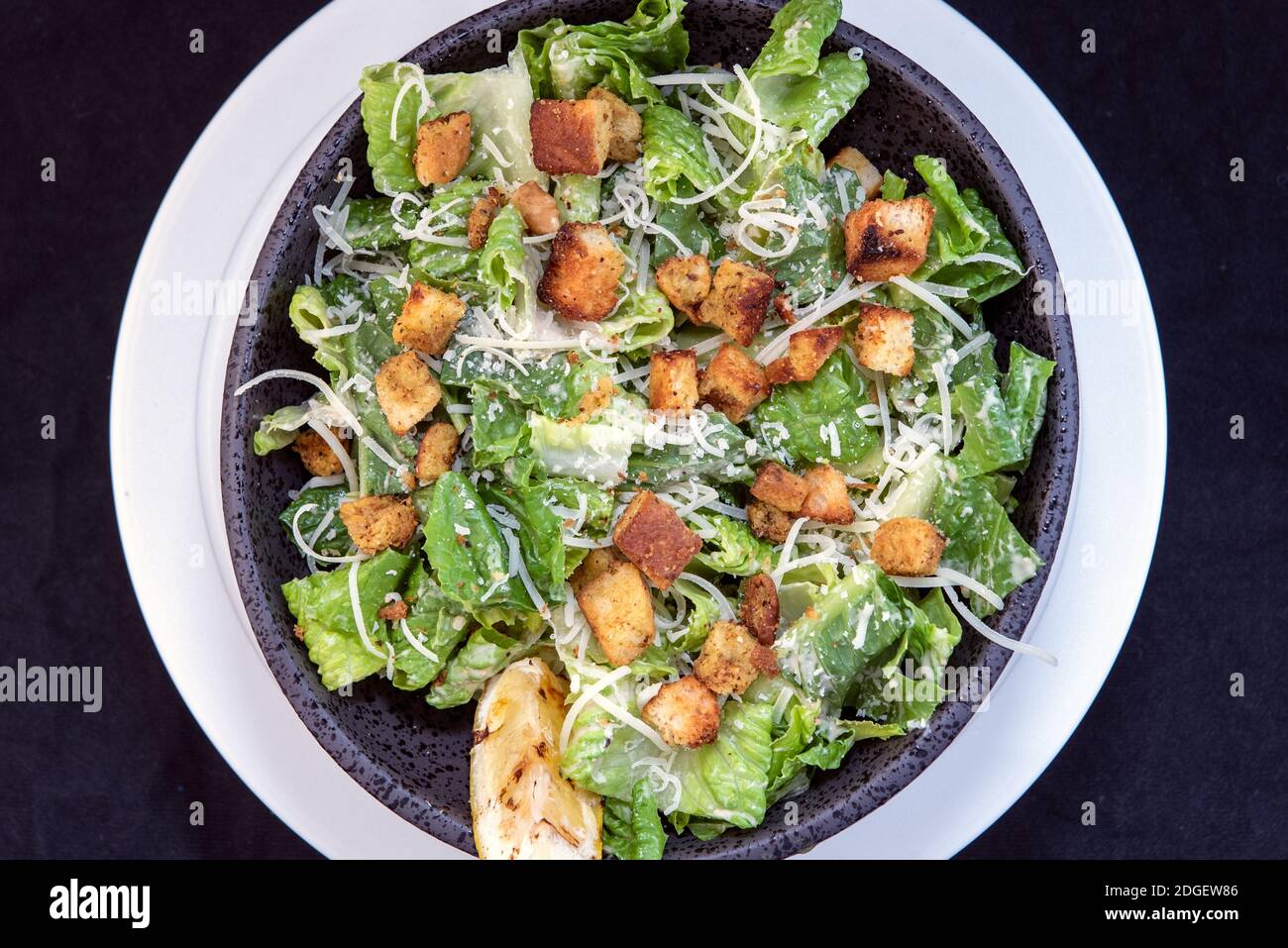 Overhead view of delicious Caesar salad topped with parmesean cheese