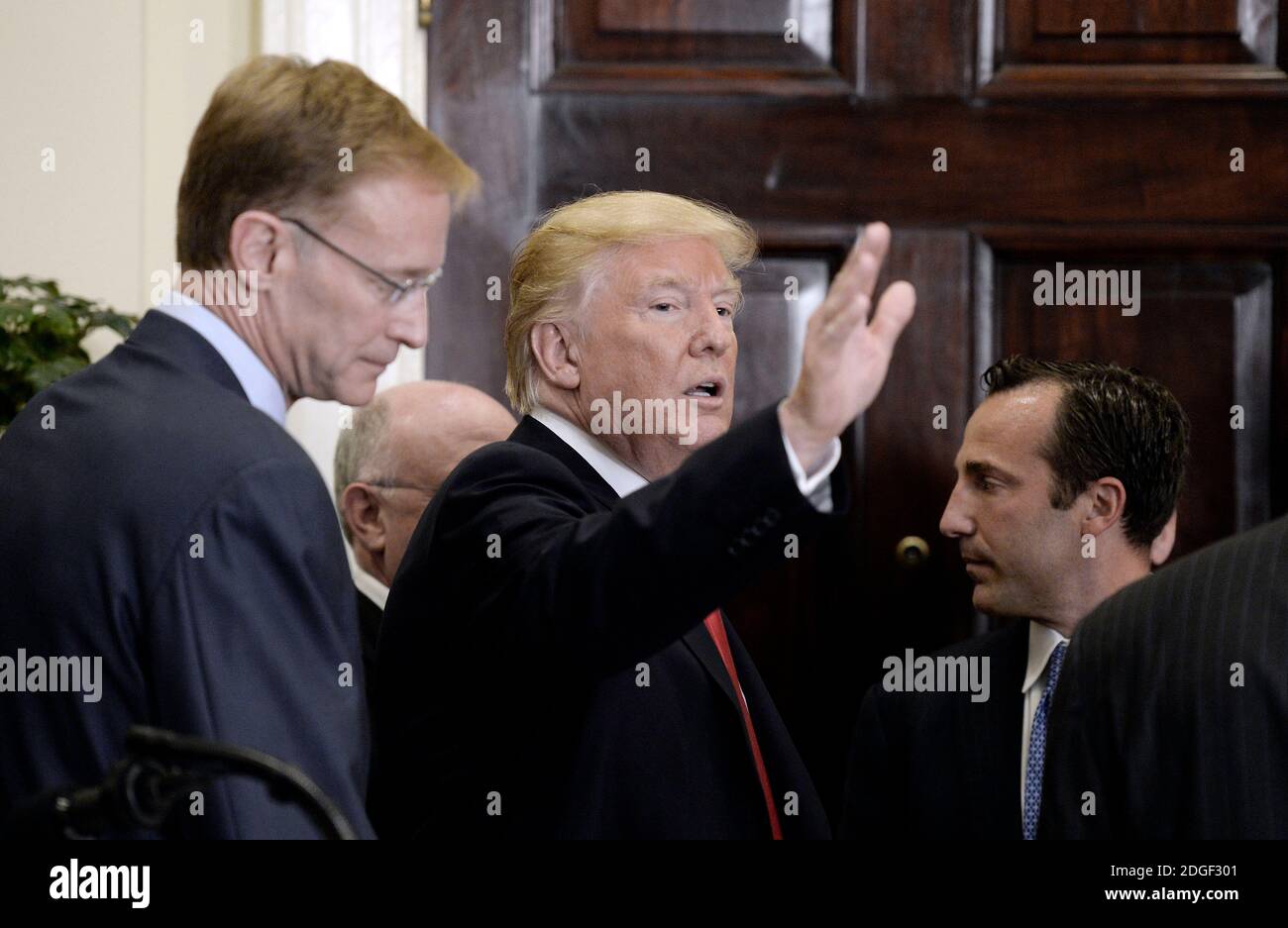 US President Donald Trump waves alongside Corning Chairman and CEO