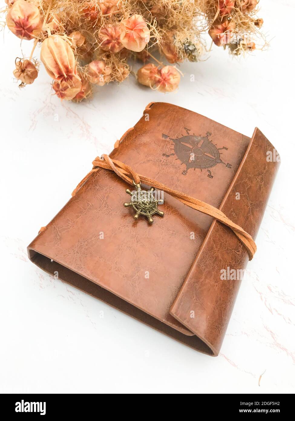 Dried flowers and a leather notebook Stock Photo