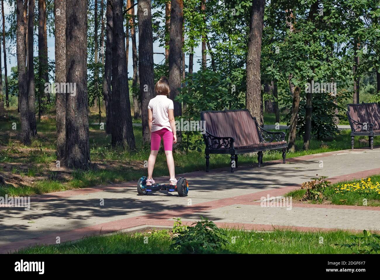 Girl riding in the Park on a self-balancing scooter Stock Photo