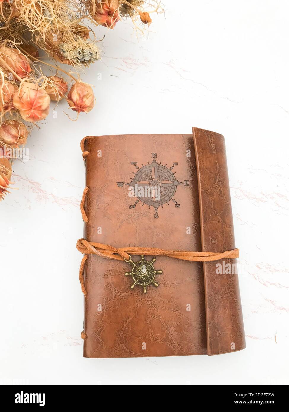 Dried flowers and a leather notebook Stock Photo