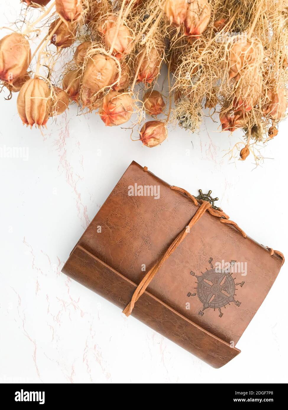 Dried flowers and a leather notebook Stock Photo
