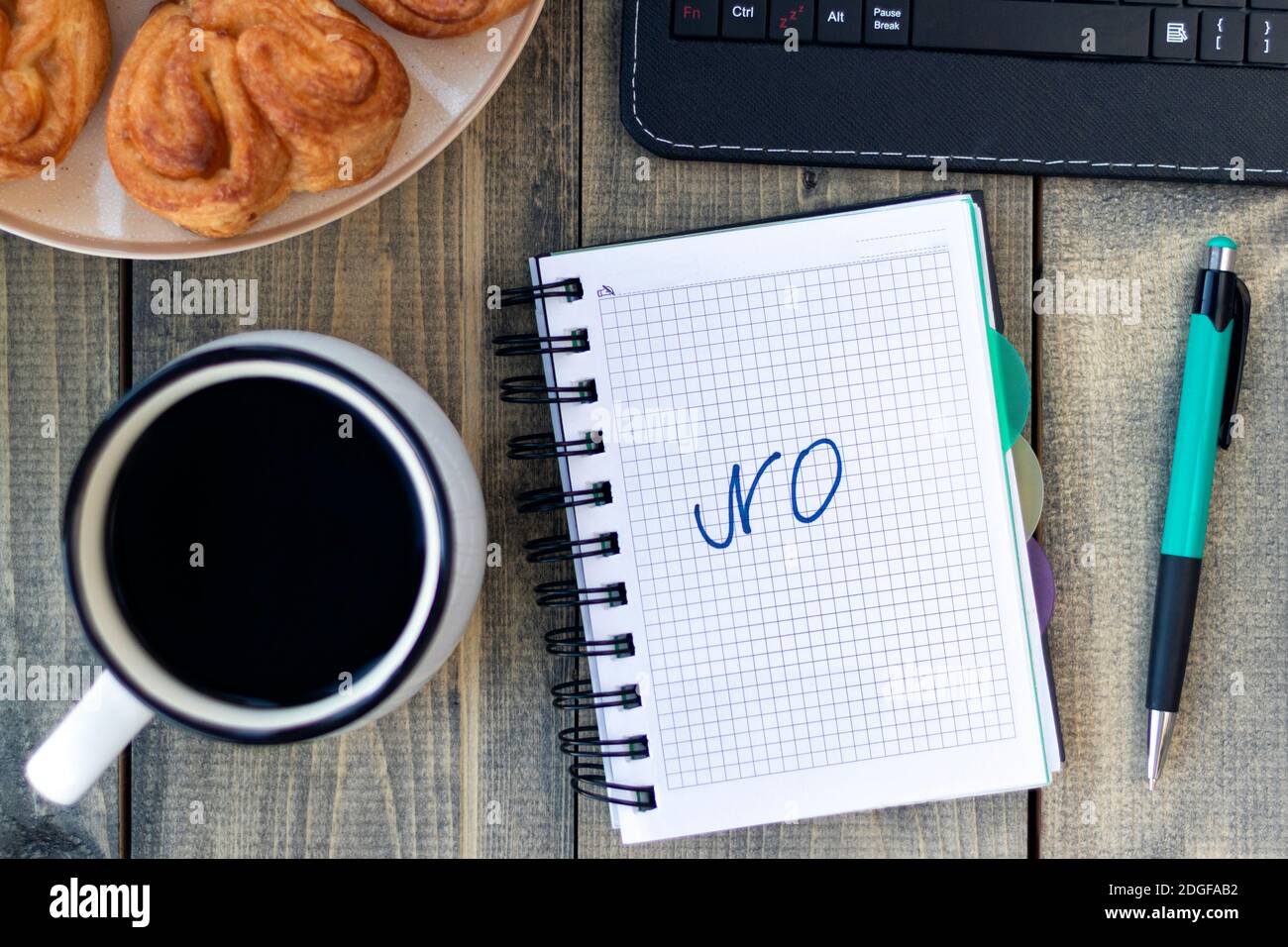 Word NO in notebook on the working table with cup of coffee and bun. Job recruiting concept. Flat lay Stock Photo
