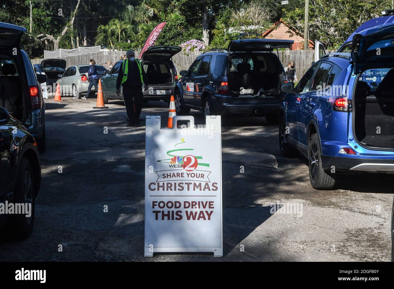Palm Bay, United States. 08th Dec, 2020. People line up in their cars to receive food at the Share Your Christmas food distribution event sponsored by the Second Harvest Food Bank of Central Florida, Hands for Healing, and WESH 2 at Eastwind Pentecostal Church. Central Florida food banks continue to struggle to meet demand amid the COVID-19 pandemic. Credit: SOPA Images Limited/Alamy Live News Stock Photo