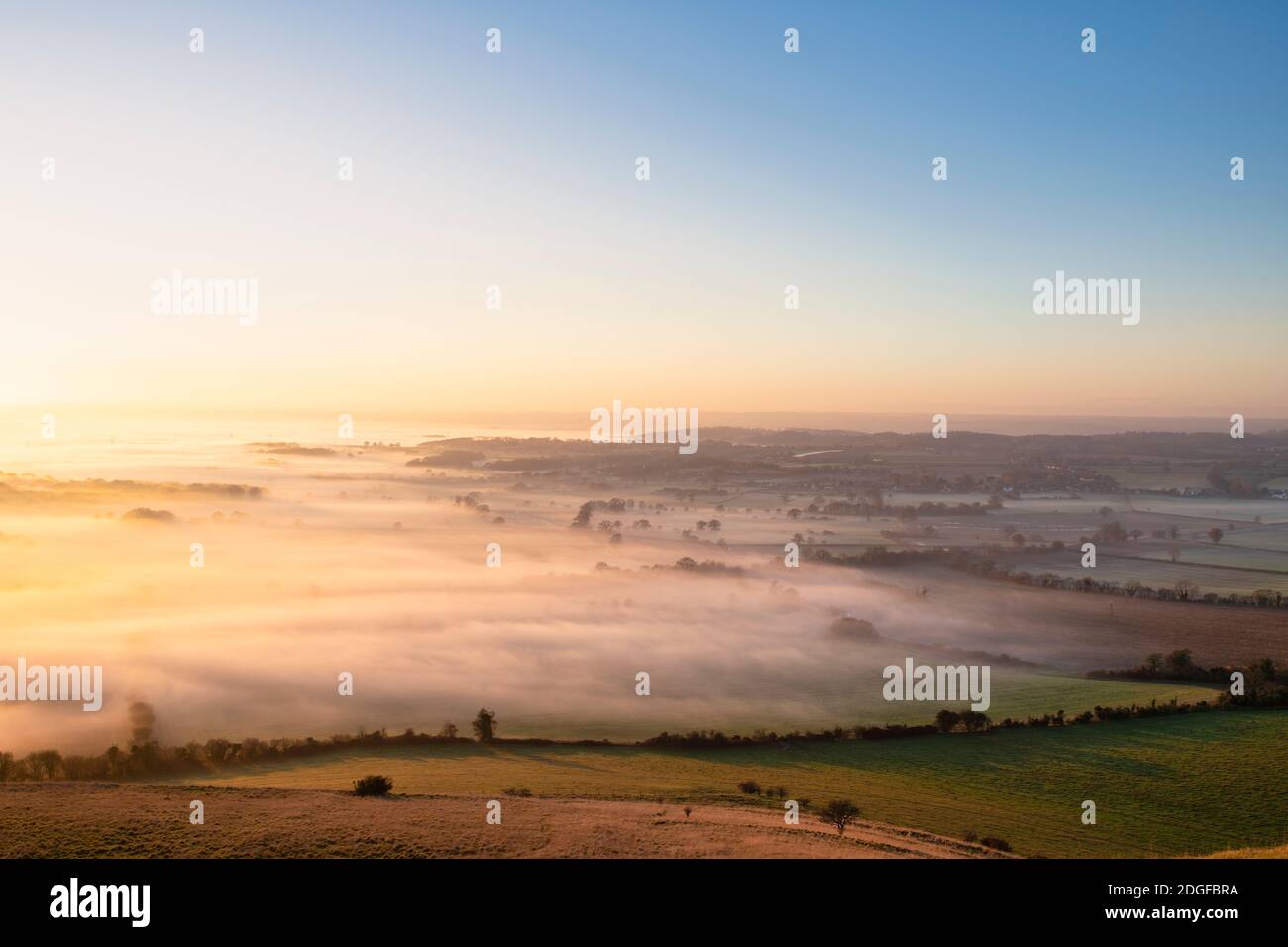 Late afternoon fog over wiltshire countryside from Roundway Hill in the Wessex Downs. Vale of Pewsey, Wiltshire, England Stock Photo