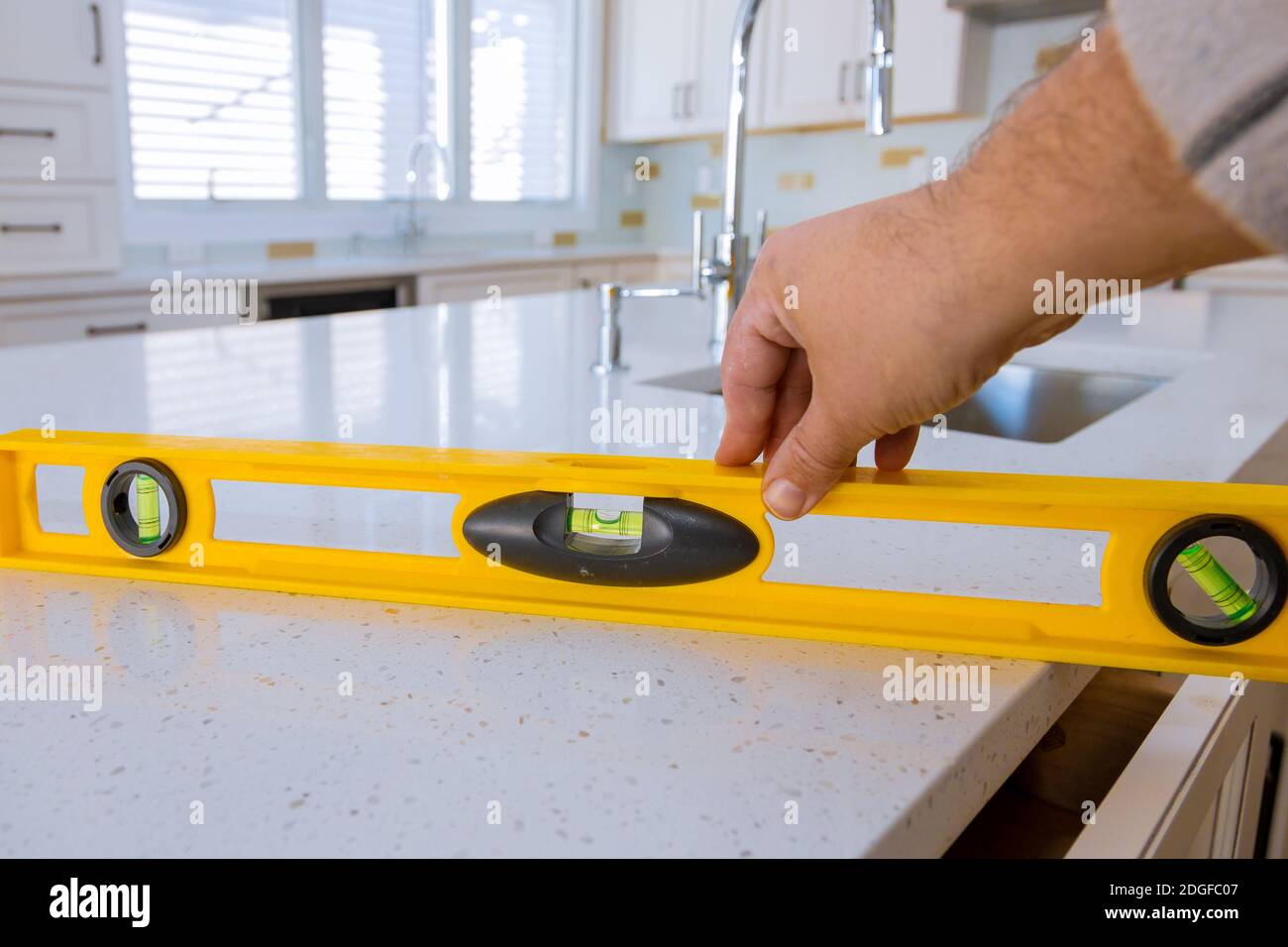 Workers installing top counter kitchen interior Stock Photo Alamy