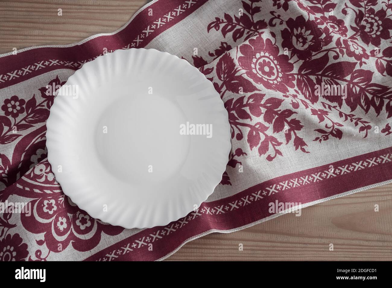 A white empty plate on a linen napkin Stock Photo