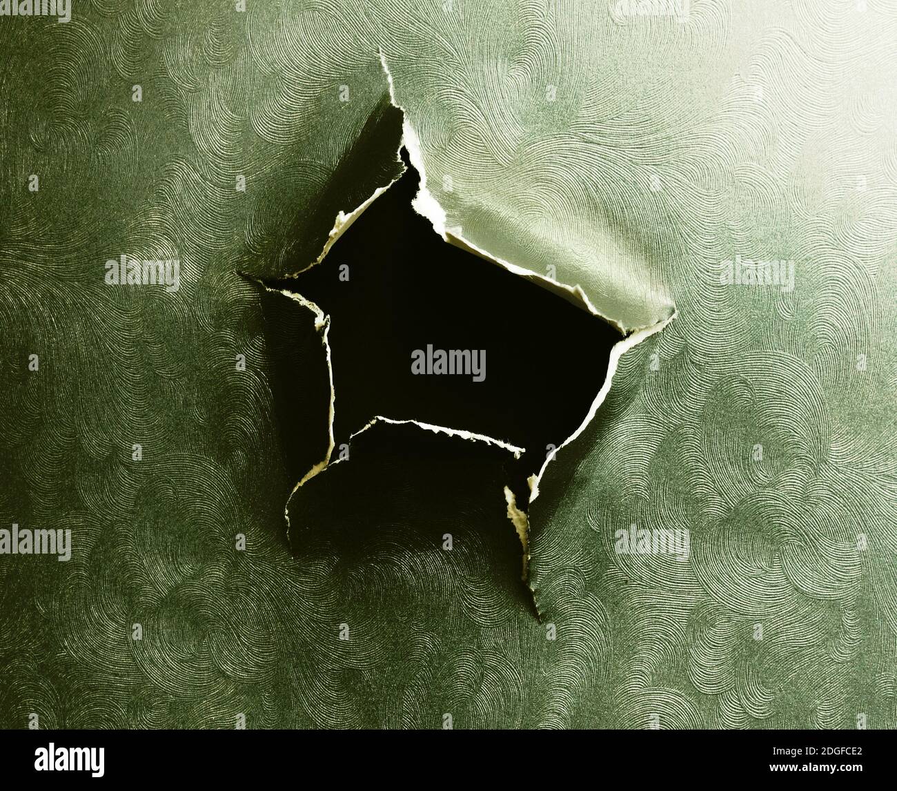 Hole torn in grunge textured ripped paper Stock Photo