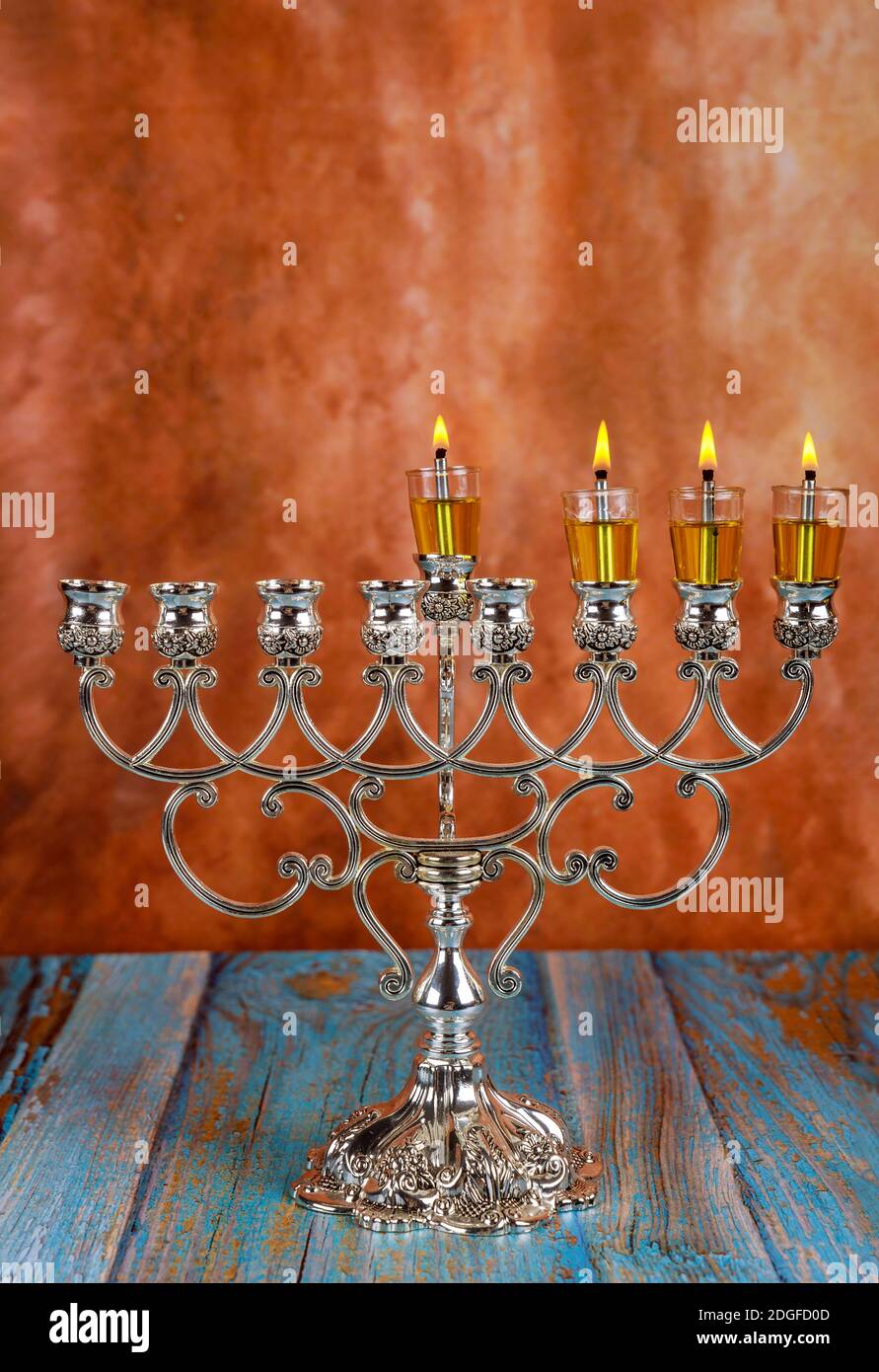 Lights candles on the third day of the Jewish holiday Hanukkah. candles are burning light of menorah Stock Photo