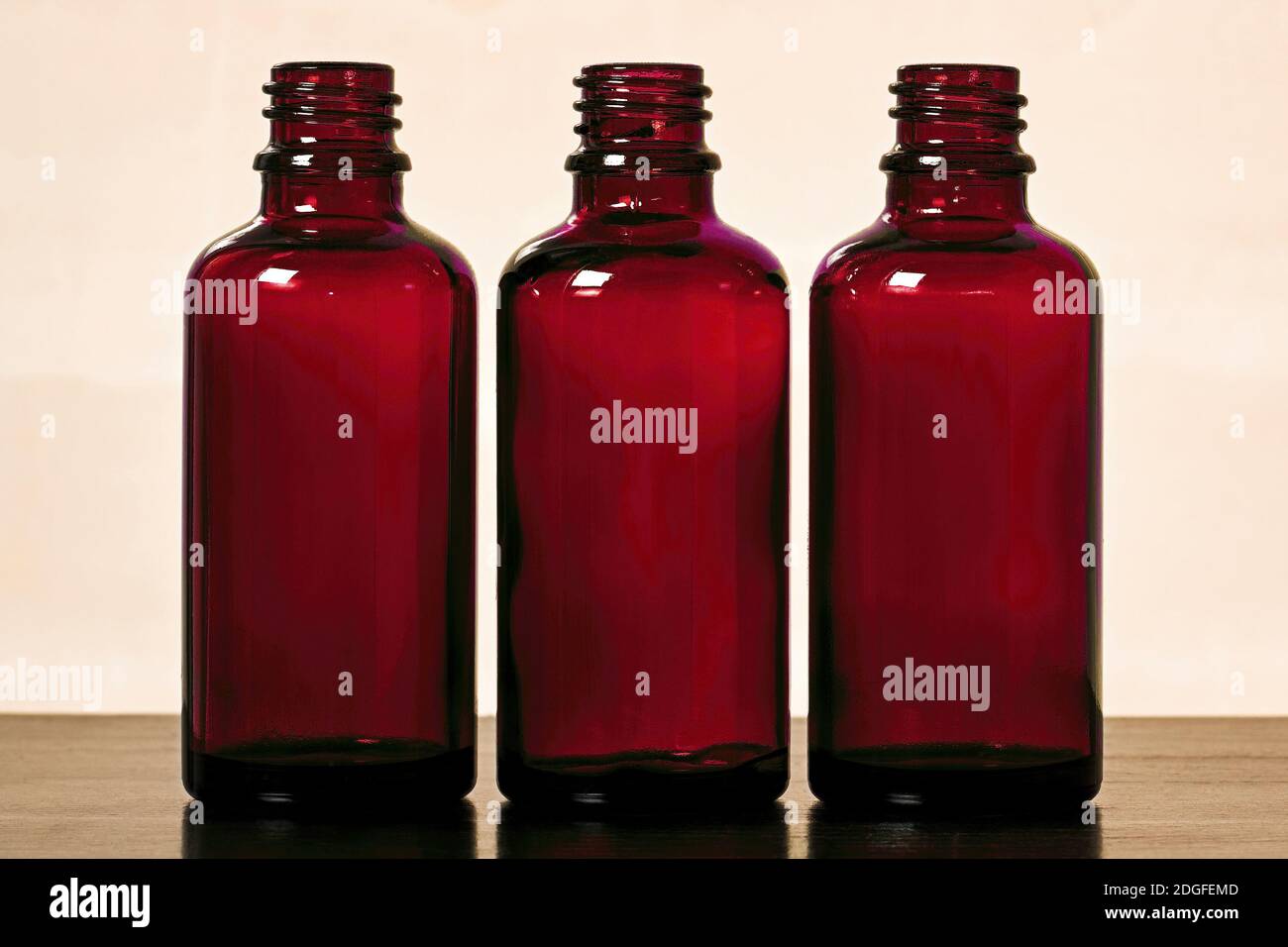 Three empty green glass bottles for women's cosmetics spray