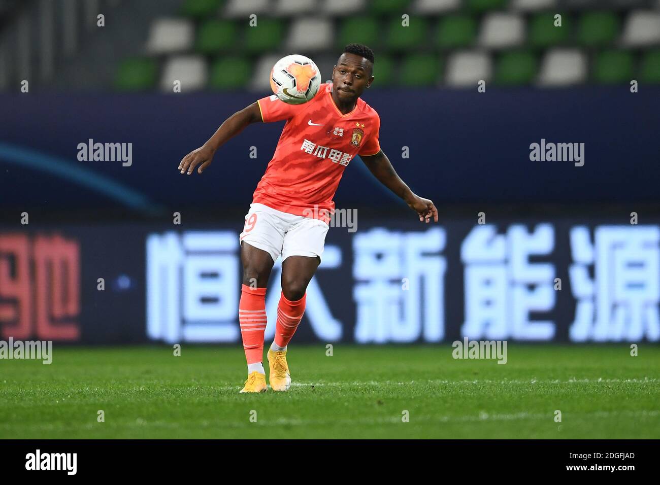 Brazilian-born Chinese football player Fernando Henrique, also known as Fei Nanduo, of Guangzhou Evergrande Taobao F.C., stops the ball during the sec Stock Photo