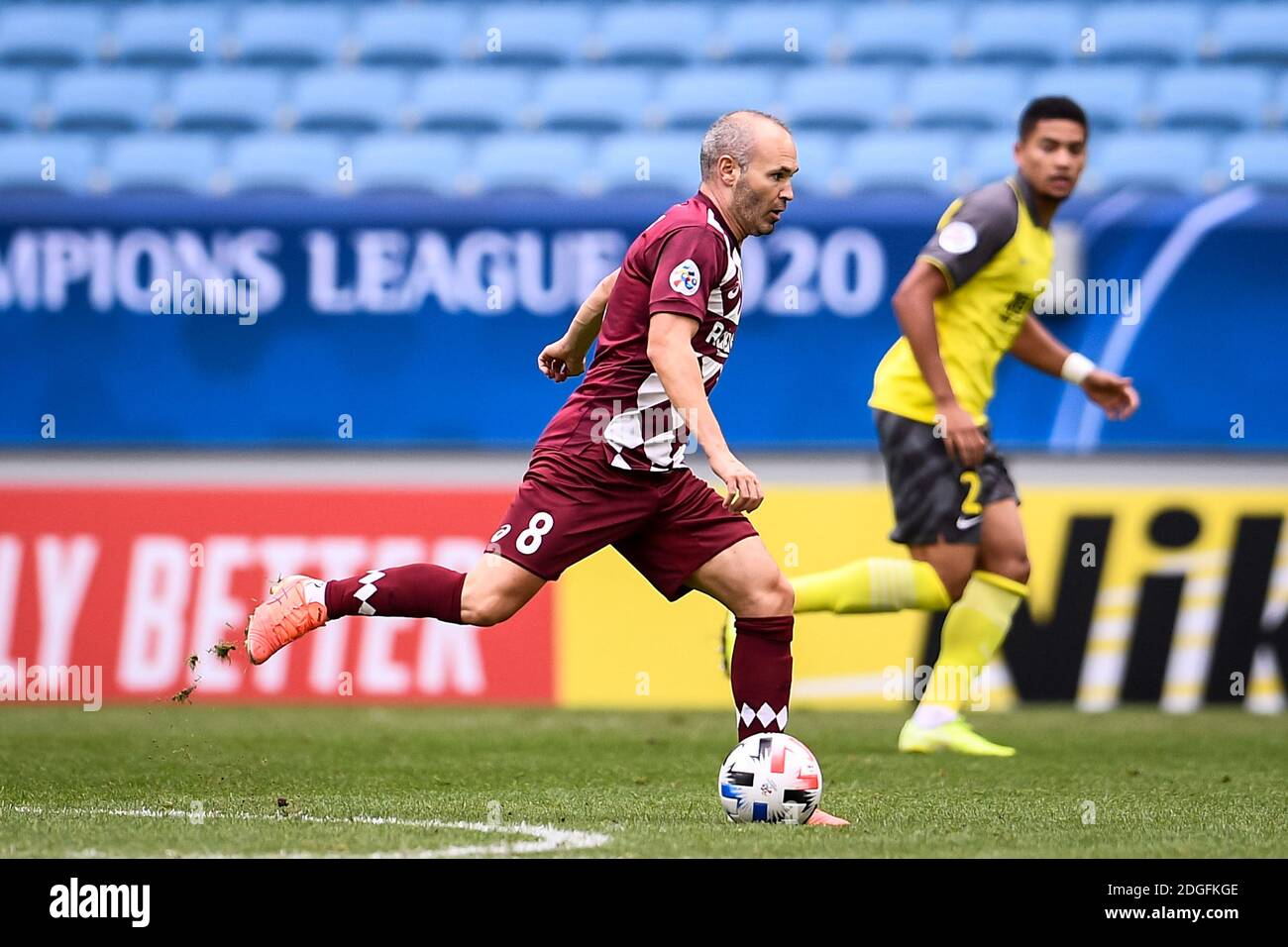 Spanish professional footballer Andres Iniesta  of Vissel Kobe, left, runs the ball during the group match against Guangzhou Evergrande Taobao F.C. at Stock Photo