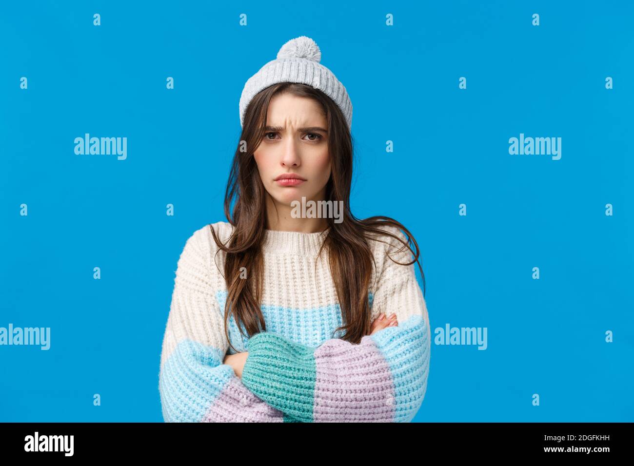 Offended unhappy, sad cute brunette woman looking mad and sulking camera, cross hands over chest defensive insulted pose, feelin Stock Photo