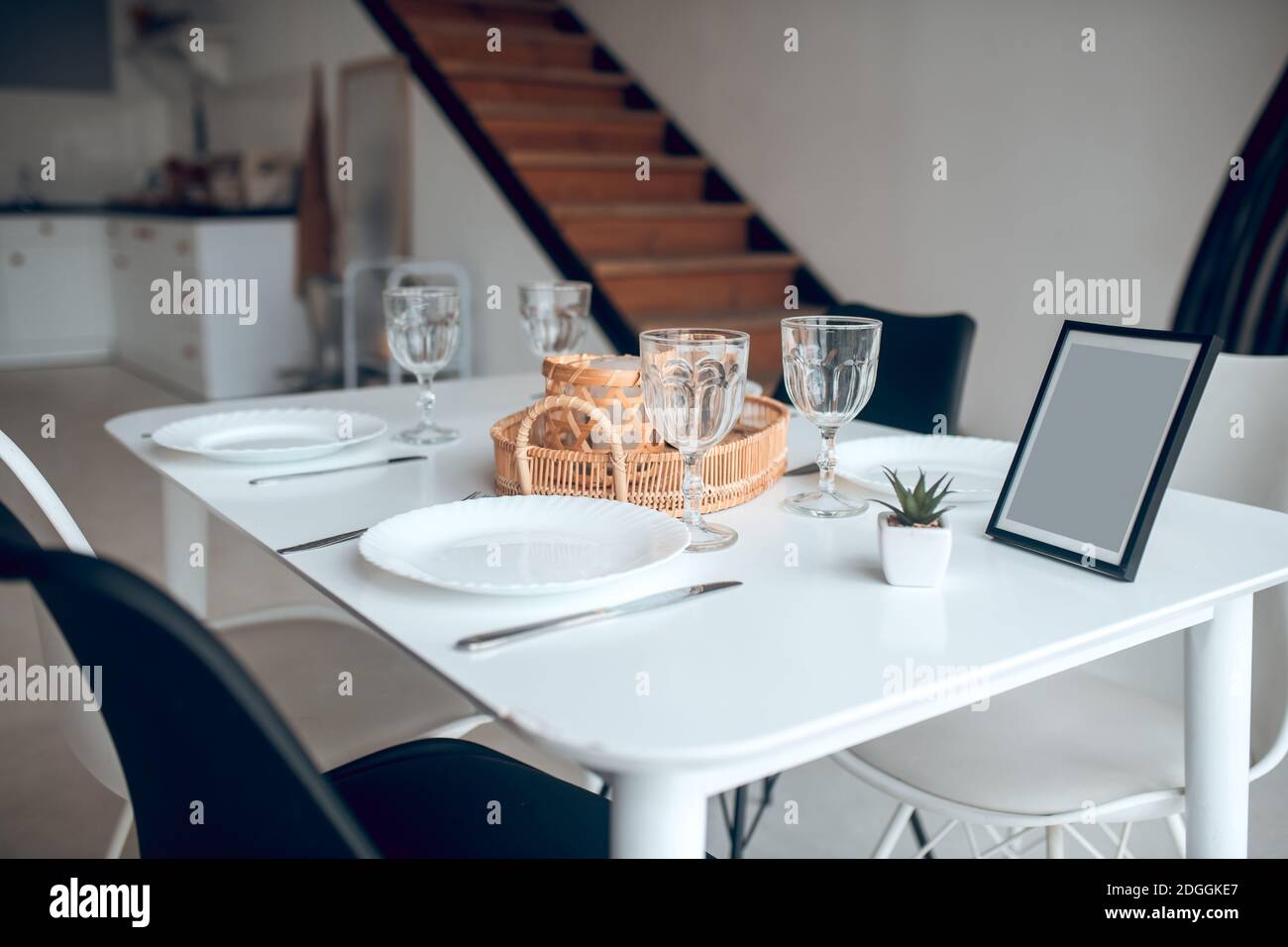 Picture of a table in the kitchen with a plate and glasses on it Stock Photo