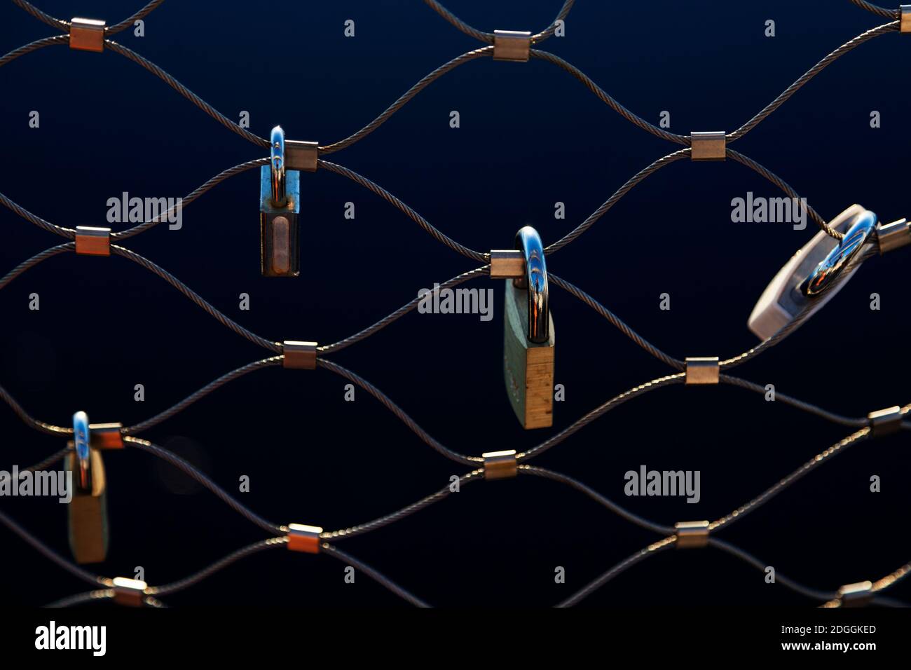 several padlocks on a bridge symbolizing love Stock Photo
