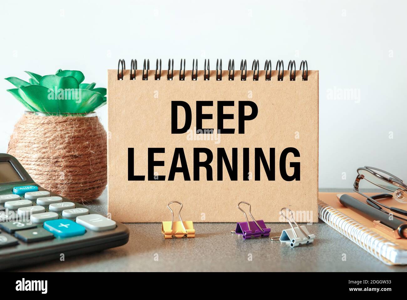 Deep learning is written in a notebook on an office table with office ...