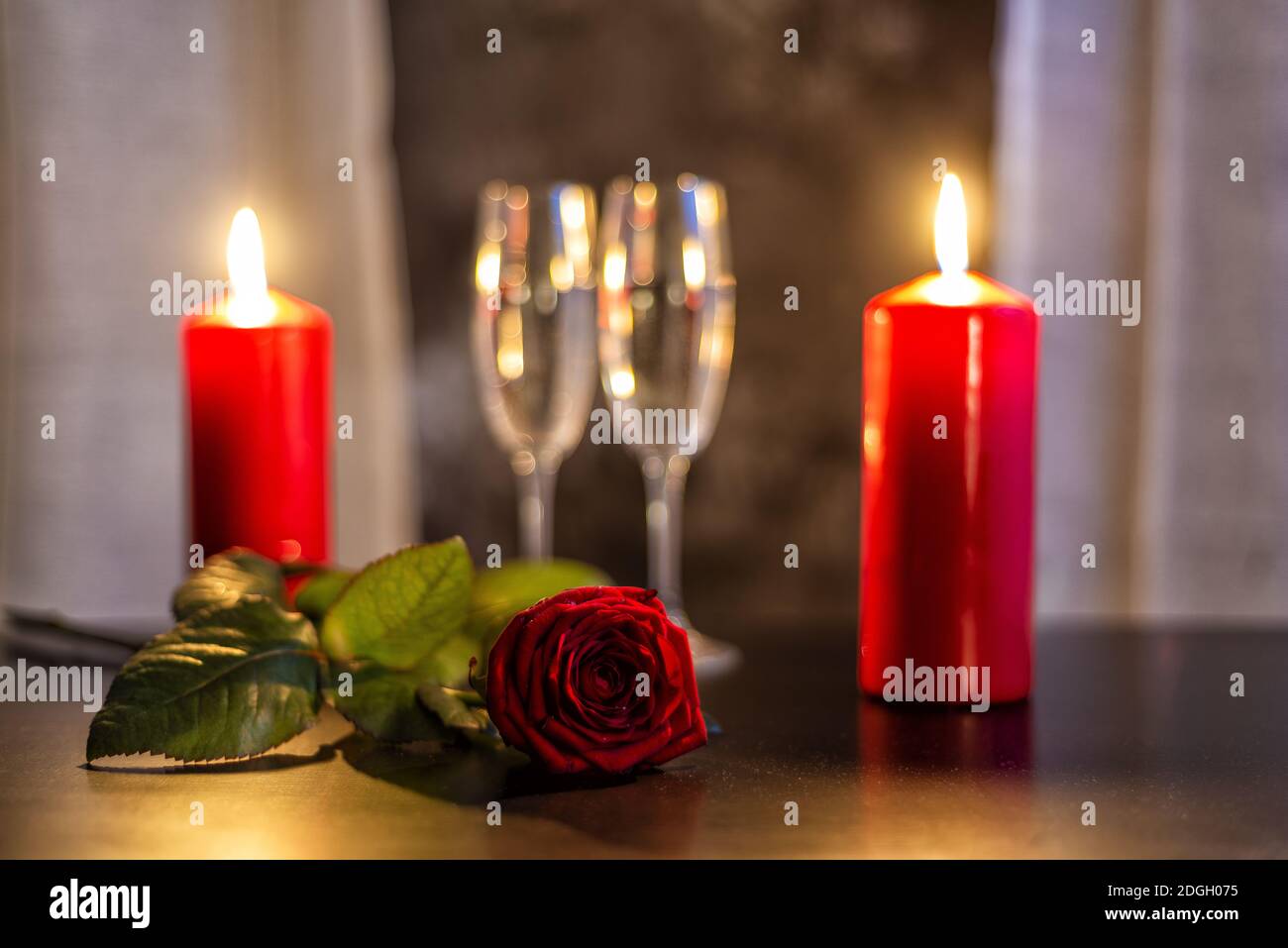 Red rose, champagne glasses and candles on Valentine's day Stock Photo