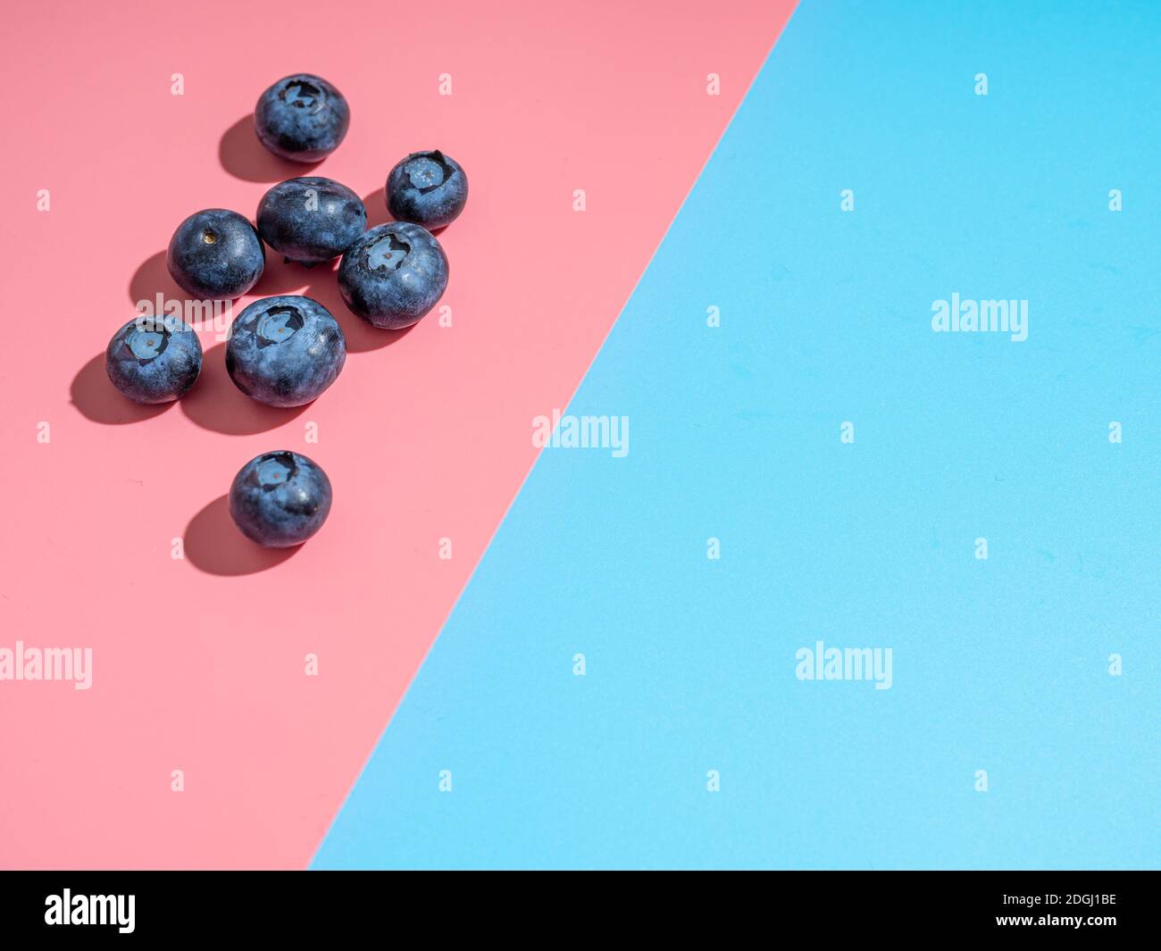 Blueberry Pink Color Blueberry on pink and blue background, copy space Stock Photo - Alamy
