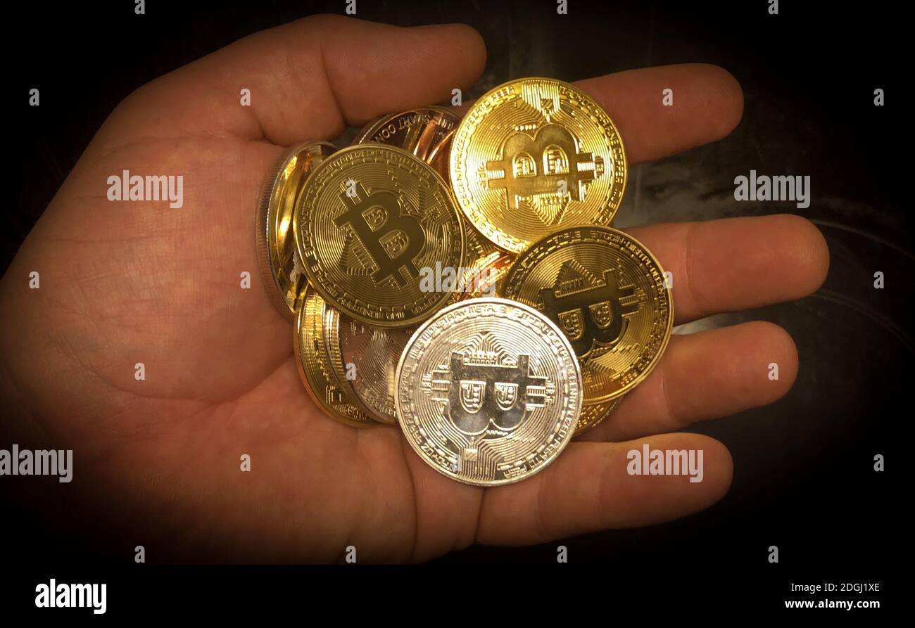 Closeup of physical bitcoin in a hand Stock Photo - Alamy