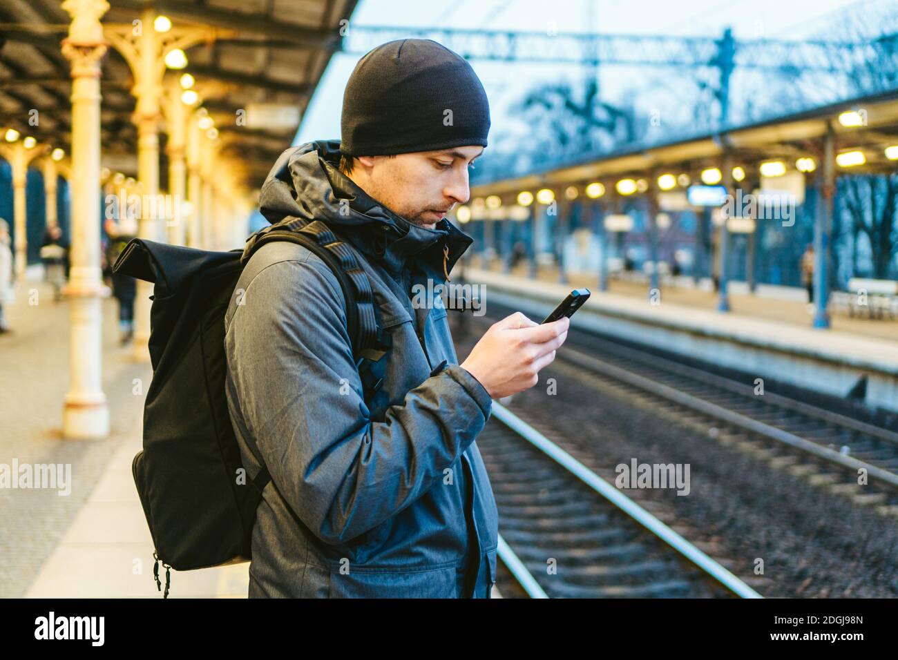 Train Station in Sopot, Poland, Europe. Attractive man waiting at the train station. Thinking about trip, with backpack. Travel Stock Photo