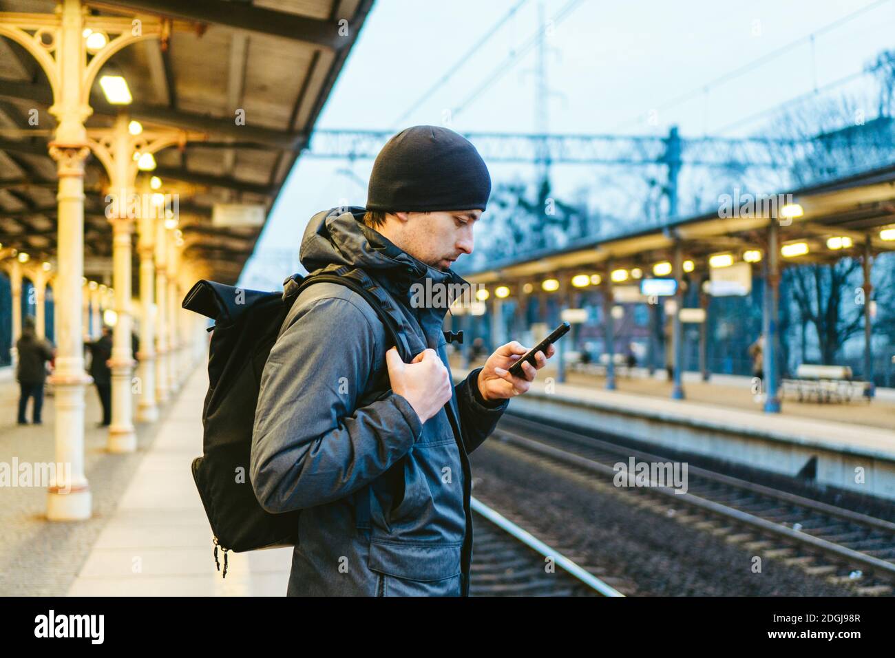 Sopot Fast Urban Railway station. young man standing and waiting train on platform. tourist travels by train. Portrait Of Caucas Stock Photo