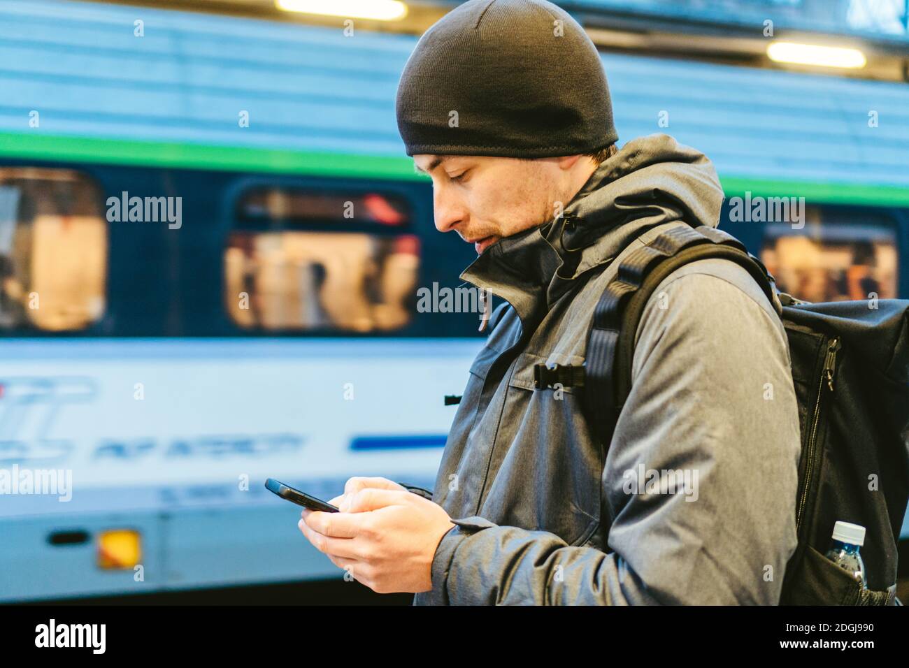 Train Station in Sopot, Poland, Europe. Attractive man waiting at the train station. Thinking about trip, with backpack. Travel Stock Photo