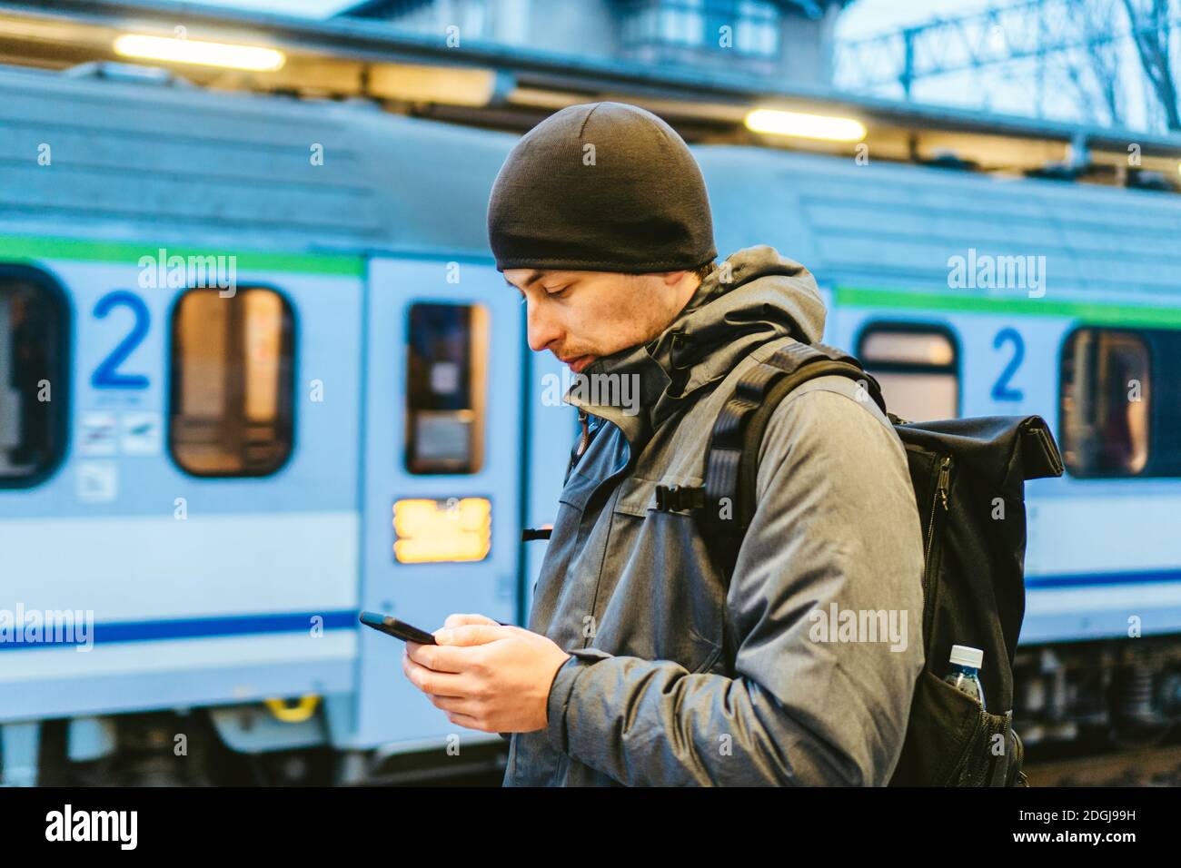 Sopot Fast Urban Railway station. young man standing and waiting train on platform. tourist travels by train. Portrait Of Caucas Stock Photo
