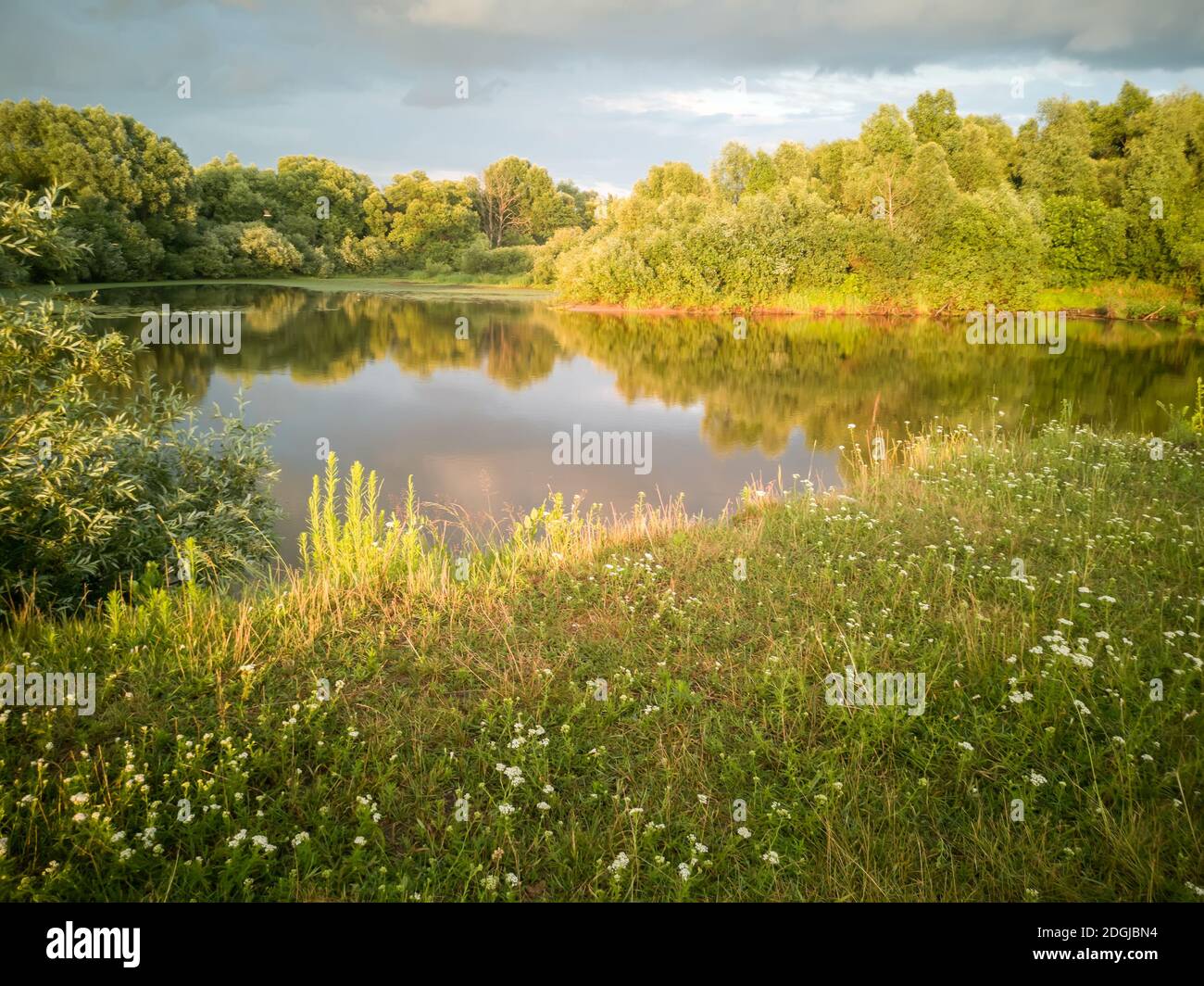 Landscape with a stormy sky at sunset. Stock Photo