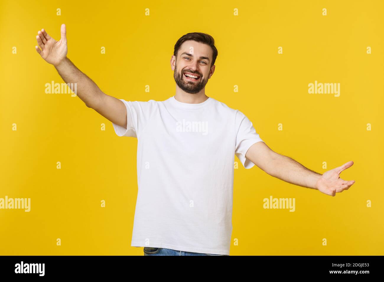 Young handsome cool man feels confident giving a hug to the camera ...