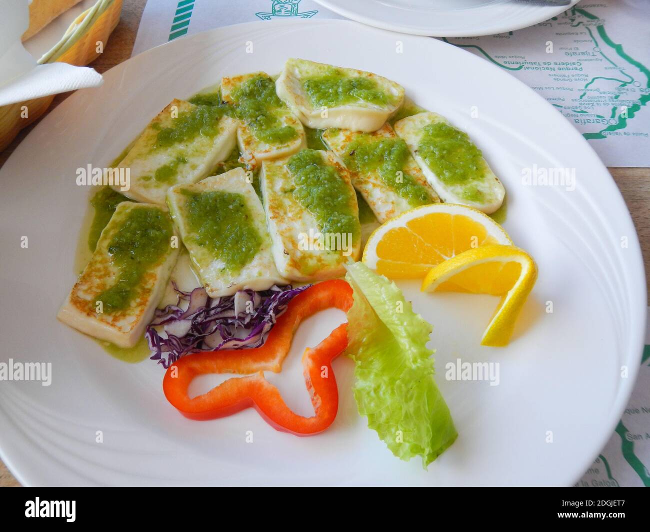 Traditional Tapas plate with Roast cheese with green mojo Stock Photo