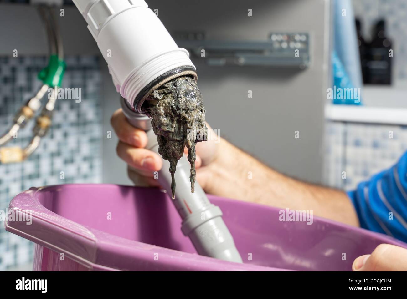 The plumber removes the blockage in the pipes, disassembles the siphon