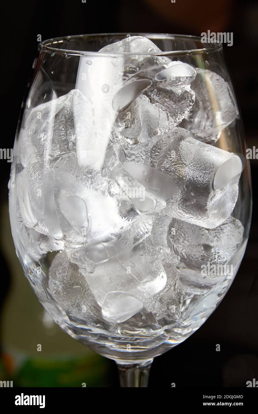Glass of wine filled with ice cubes Stock Photo Alamy