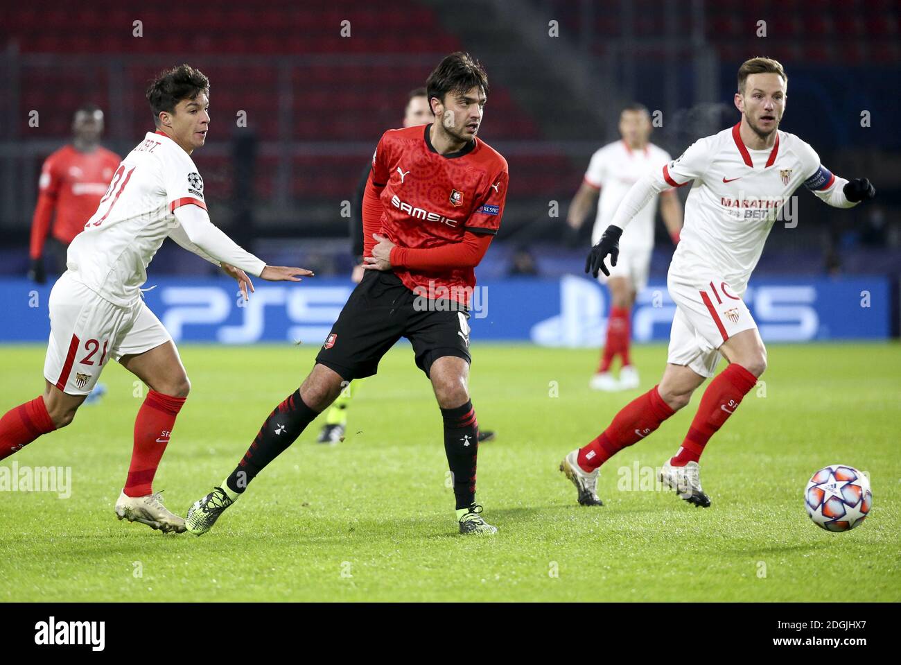Clement Grenier of Stade Rennais between Oliver Torres and Ivan Rakitic of Sevilla FC during the UEFA Champions League, Group E football match between Stade Rennais and Sevilla FC (FC Seville) on December 8, 2020 at Roazhon Park in Rennes, France - Photo Jean Catuffe / DPPI / LM Stock Photo