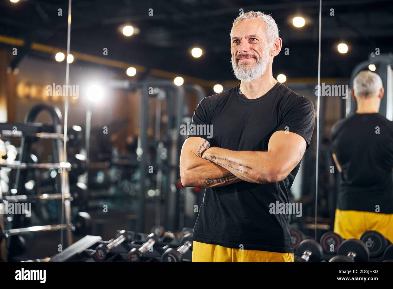 Coach with a pleased smile looking in front of him Stock Photo - Alamy