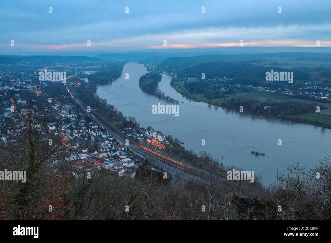 View of Königswinter in Germany along the Rhine River at sunset with cloudy sky. Stock Photo