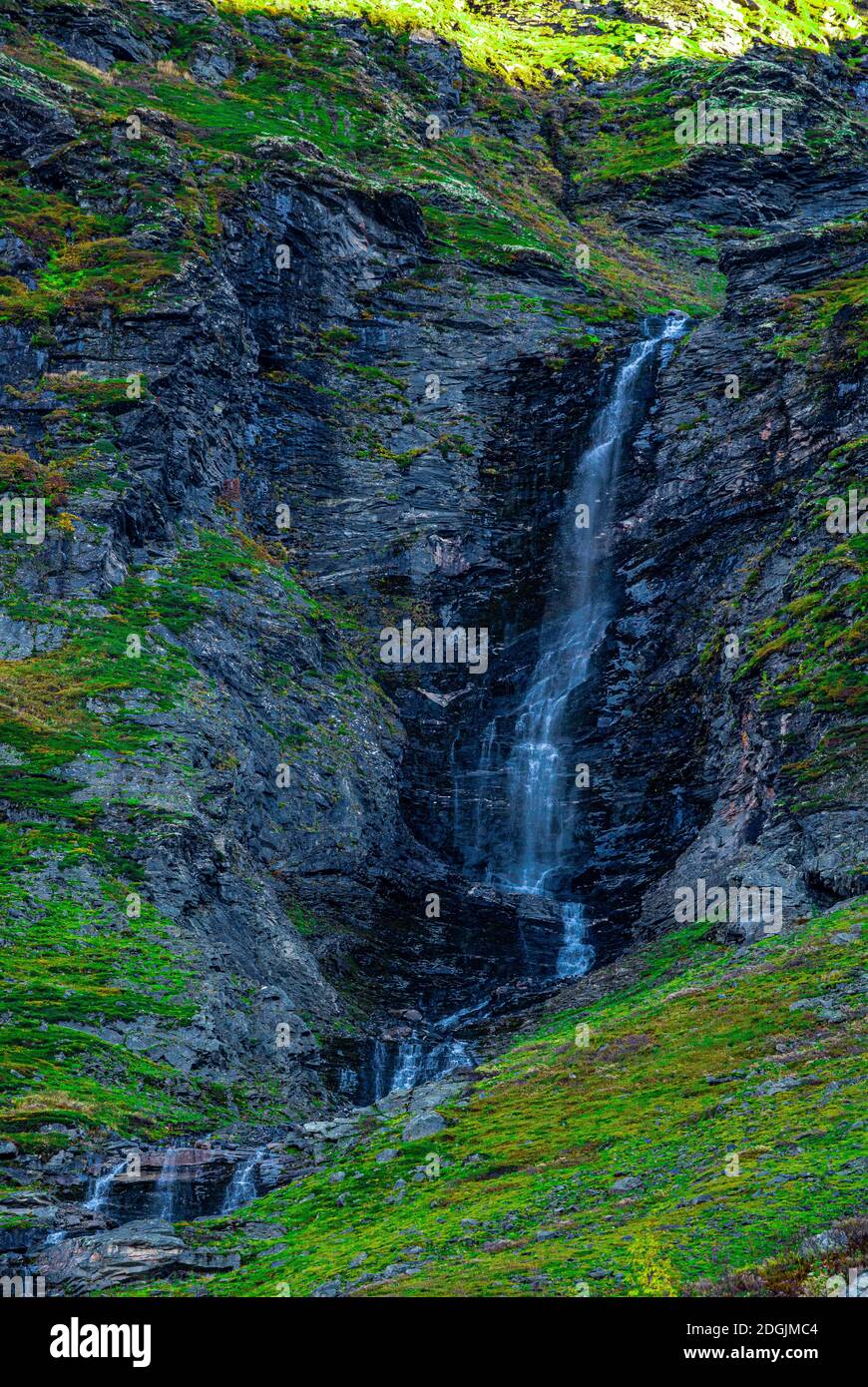 Waterfall free falling from a steep mountain slope. . High quality photo Stock Photo